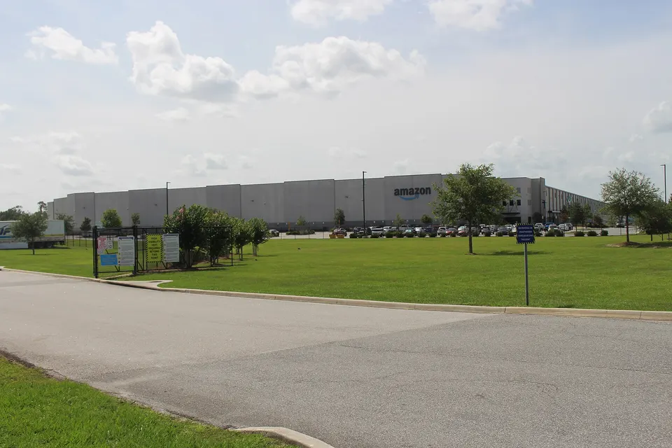 Exterior of an Amazon fulfilment centre in Ocala, Florida, with a parking area in front